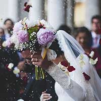 周囲に祝福されながら結婚する花嫁と花婿